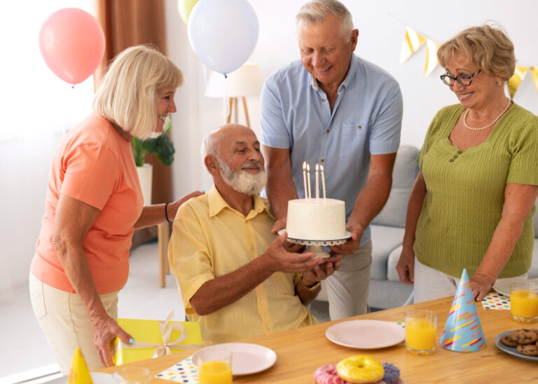 elderly man celebrating birthday with family and loved ones
