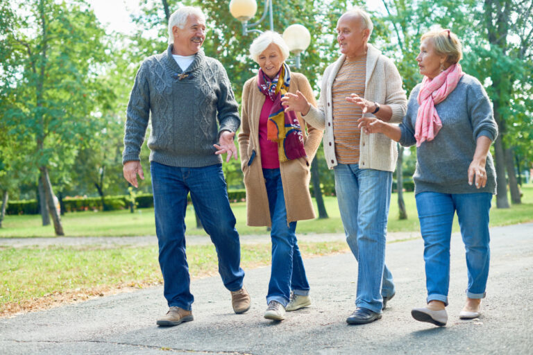 happy senior couples walking outdoors enjoying retirement lifestyle