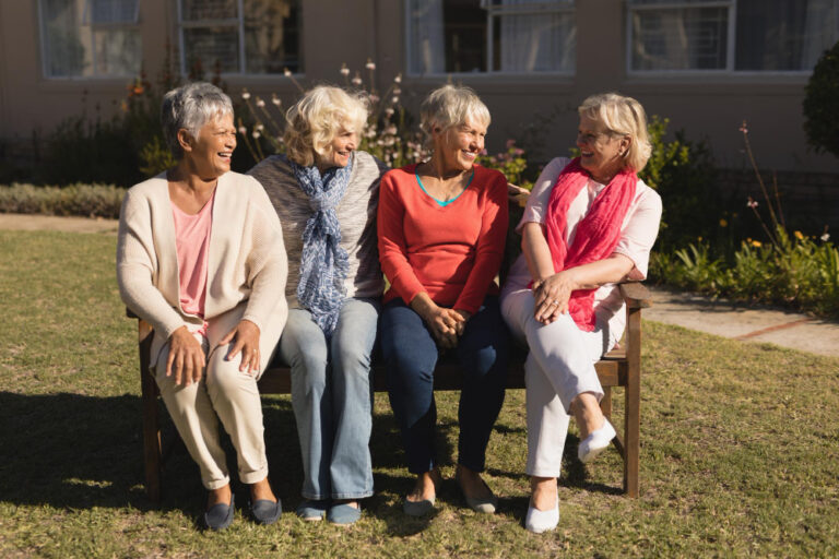 group of elderly friends enjoying time together outdoors