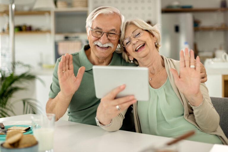 senior couple using tablet to review financial plans and retirement options