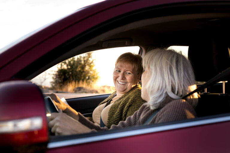happy senior couple enjoying time together in car