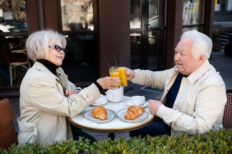 elderly couple enjoying drinks and conversation together