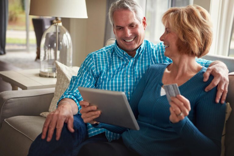 senior couple reviewing financial plan and retirement strategy on tablet
