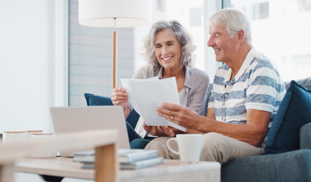 senior couple reviewing financial documents and care planning options