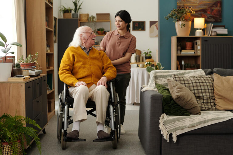caregiver assisting senior in wheelchair with daily living support