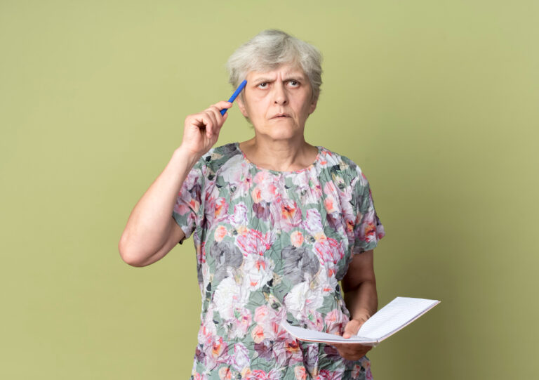 older woman reviewing paperwork and making financial decisions