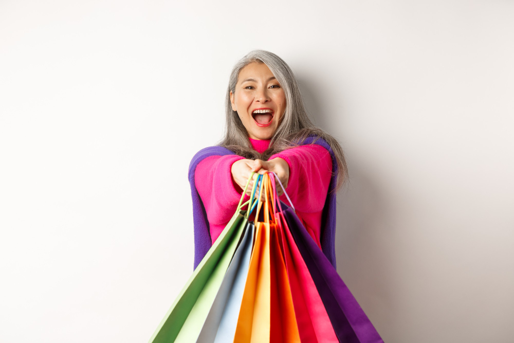 happy senior woman enjoying shopping with financial freedom in retirement