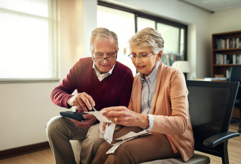 senior reviewing bills and managing retirement finances